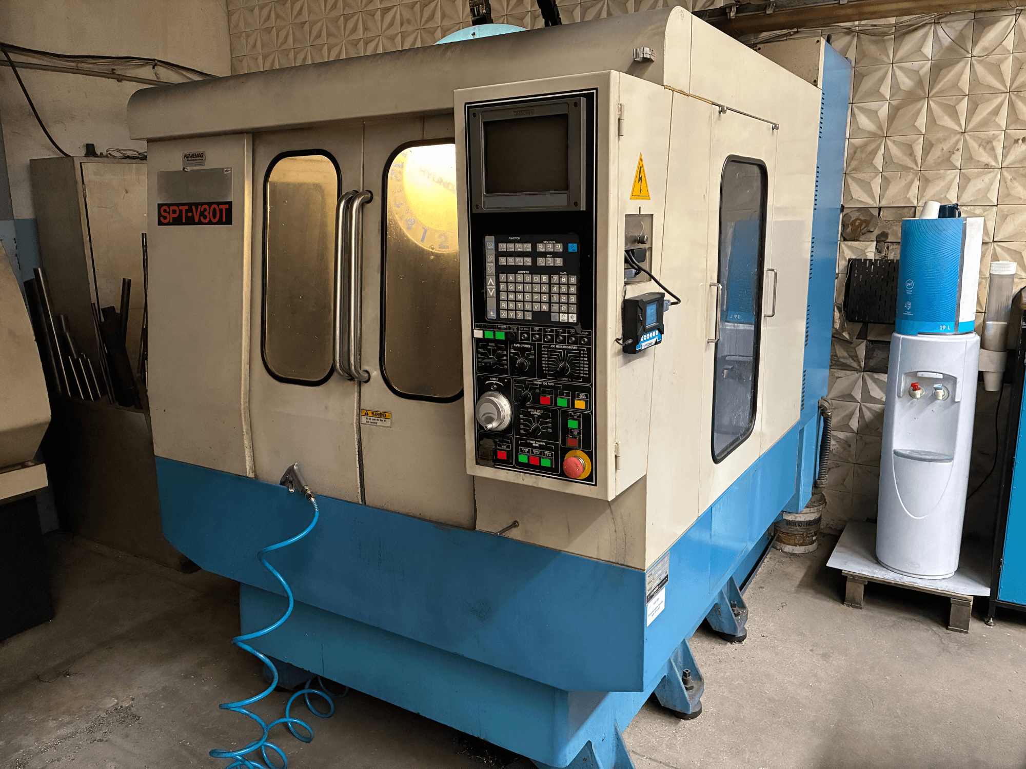 Hydraulic injection moulding machine DEMAG Ergotech 150-610 Viva in a workshop, front view with control panel visible.